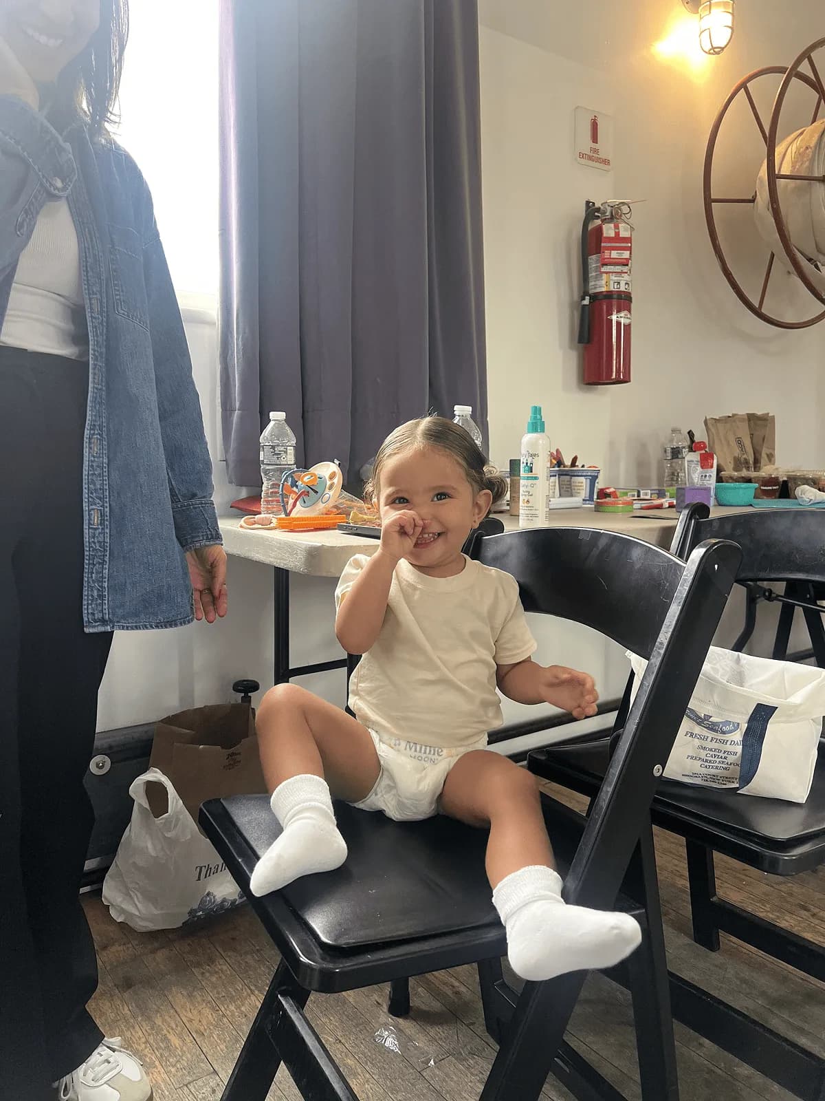 Toddler wearing a Millie Moon nappy sitting on a chair backstage at the photo shoot